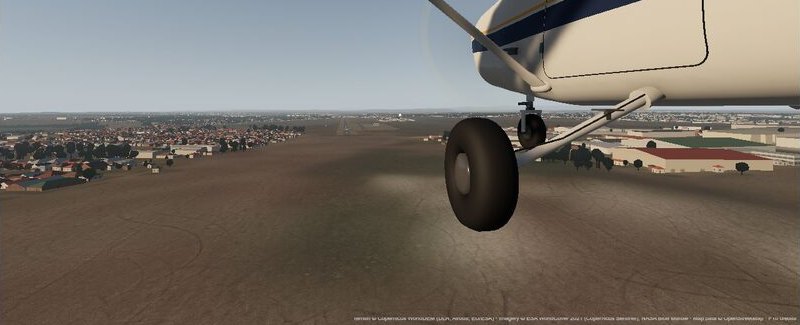 The main wheel and strut on final approach